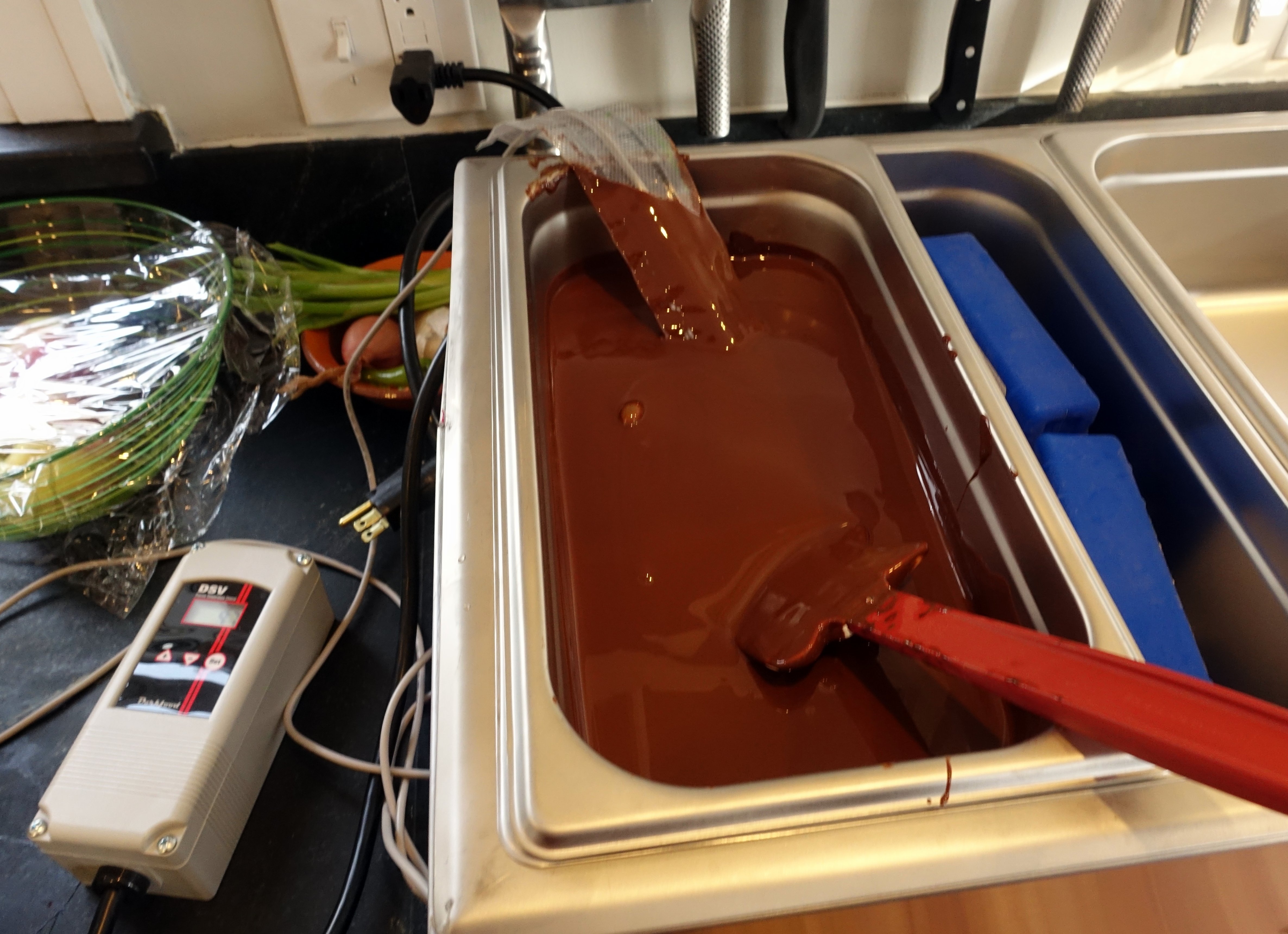 Chocolate ready for enrobing the cut up sponge pieces