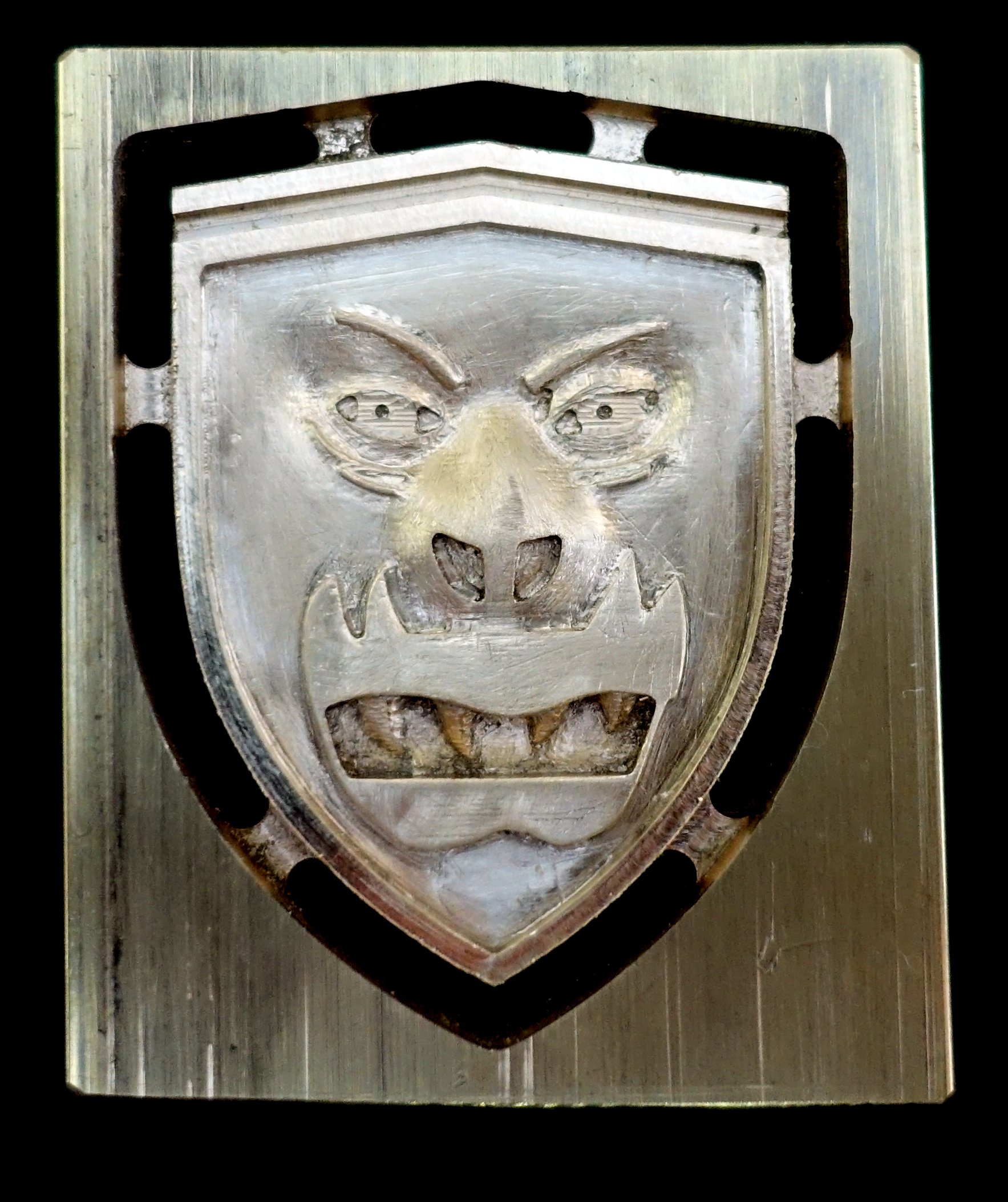 Brass after some hand finishing. Some details (for example, the outside corner of the left eye) could benefit from re-machining with a smaller end mill. The results of using a 0.019" tool are seen in the following image. a bit this small needs to be moved very slowly and takes long time hours